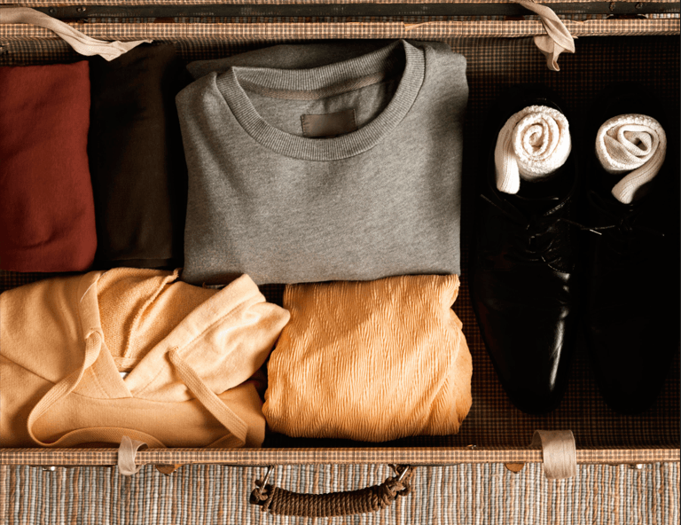 top view vintage suitcase with casual clothes