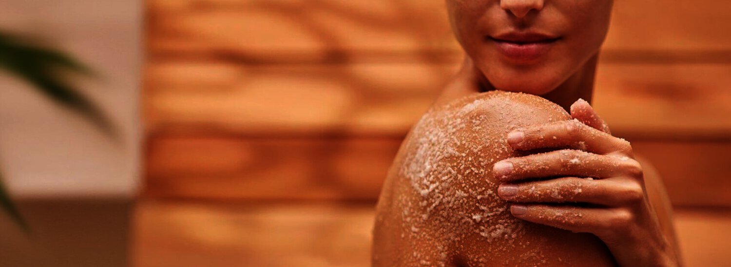 Tropic Skincare how to get a better discount image, featuting woman holding her shoulder against orange background
