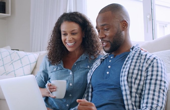 Two people looking at a laptop screen