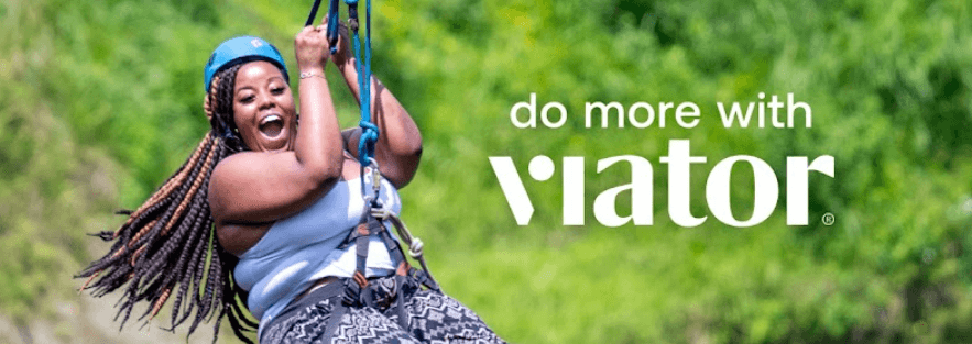 Viator deals page image showing a woan ziplining against a green backdrop. Text says do more with Viator