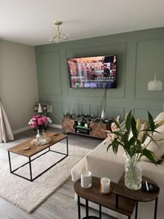 Stylish room setting showing panelling on the far wall containing a TV