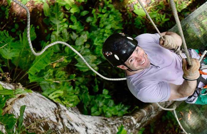 Guy climbing rope