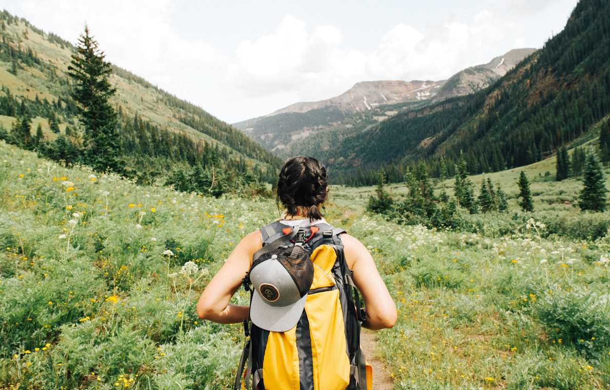 Adventure holiday - woman backpacking in mountains
