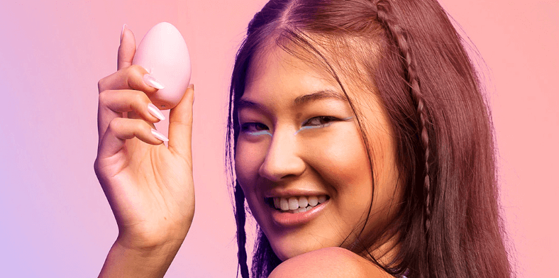 Wild Secrets ways to save image. Banner features a woman holding an egg massager with a pink filter overlaid