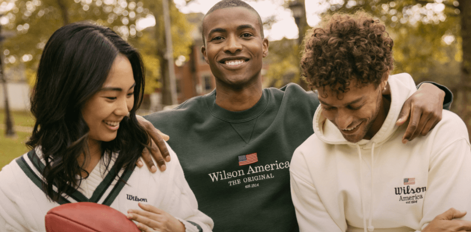 Wilson how to save banner - Two men and a woman laughing while wearing branded apparel