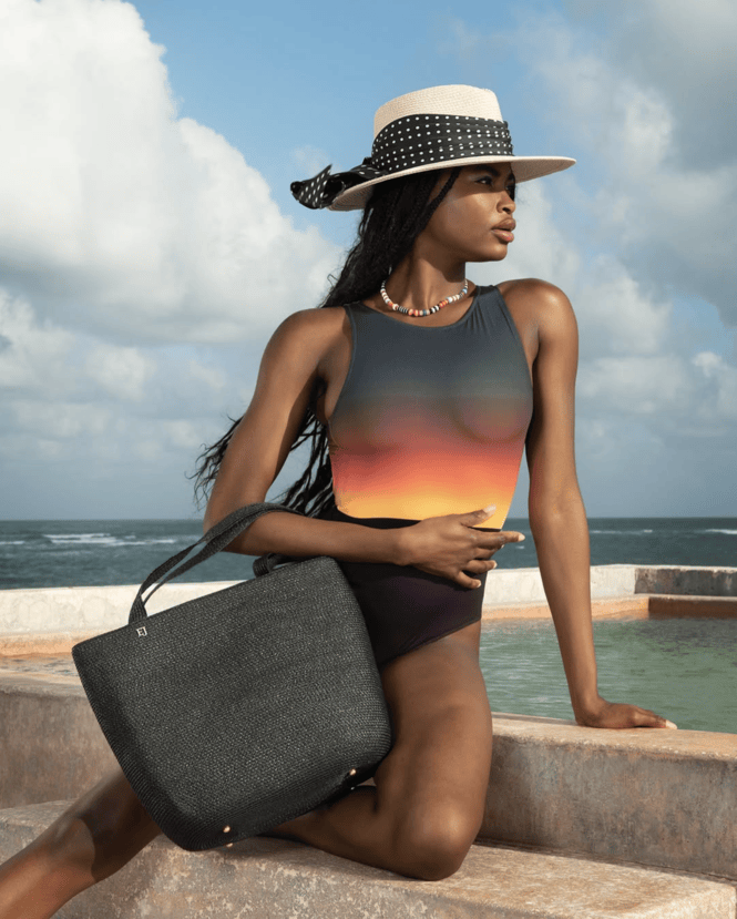Woman wearing Eric Javits beach hat and purse