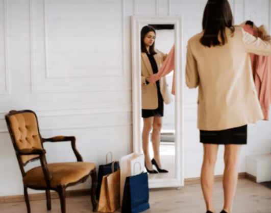 woman-stood-next-to-mirror-shopping-bags