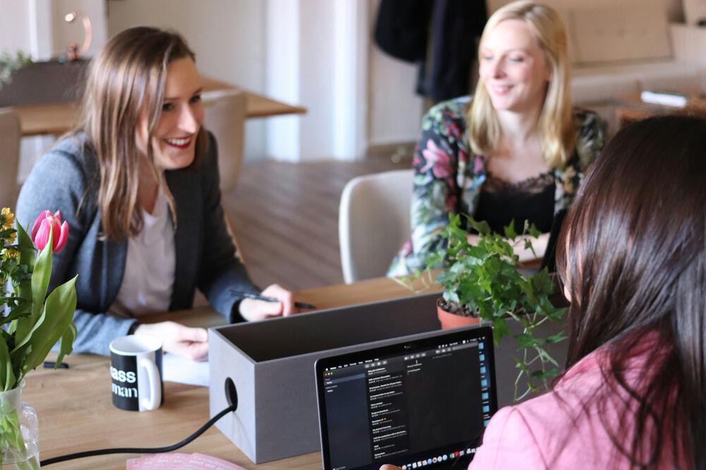 Three women chatting in an office