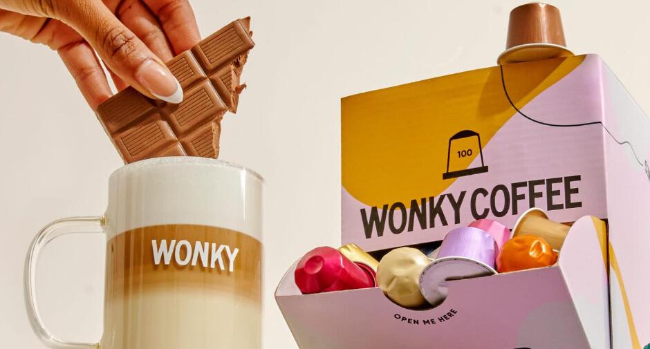 Wonky Coffee how to save banner - Hand dipping chocoate into a mug printed with Wonky on the side alongside a box of pods