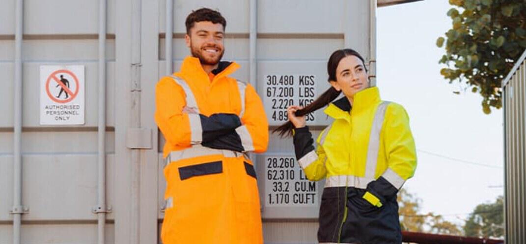 WorkwearHub deals page banner - A man and woman in high-vis clothing next to a shipping container