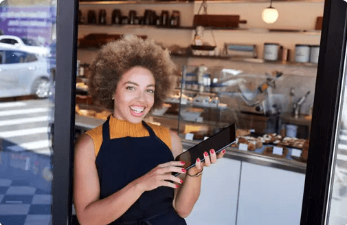 Yelp for Small Business restaurant owner standing in door